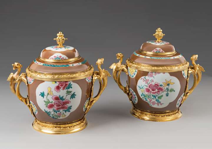 A pair of ormolu mounted lidded vases with capuchin-brown ground